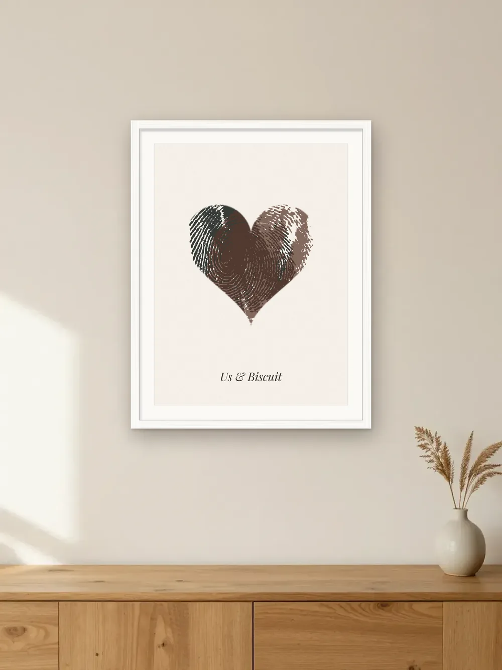 Gift for pet lovers mockup: a fingerprint heart made from two real ink prints, framed on a wall labelled “Us & Biscuit”