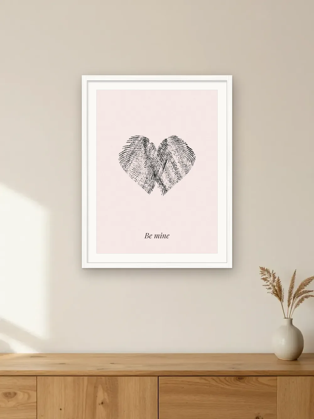Valentine’s Day gift mockup: a fingerprint heart made from two real ink prints, on blush paper in a white frame labelled “Be mine”